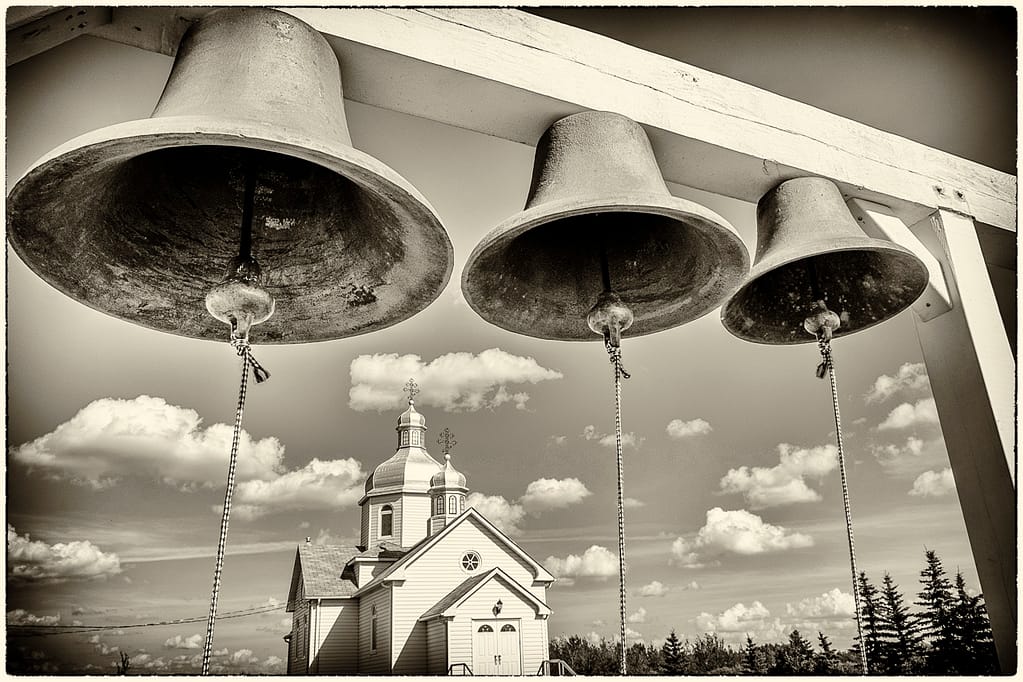 Instead of a belfry, three church bells are fastened to a post just west of the church. The bells were donated by one of the early pioneer families.