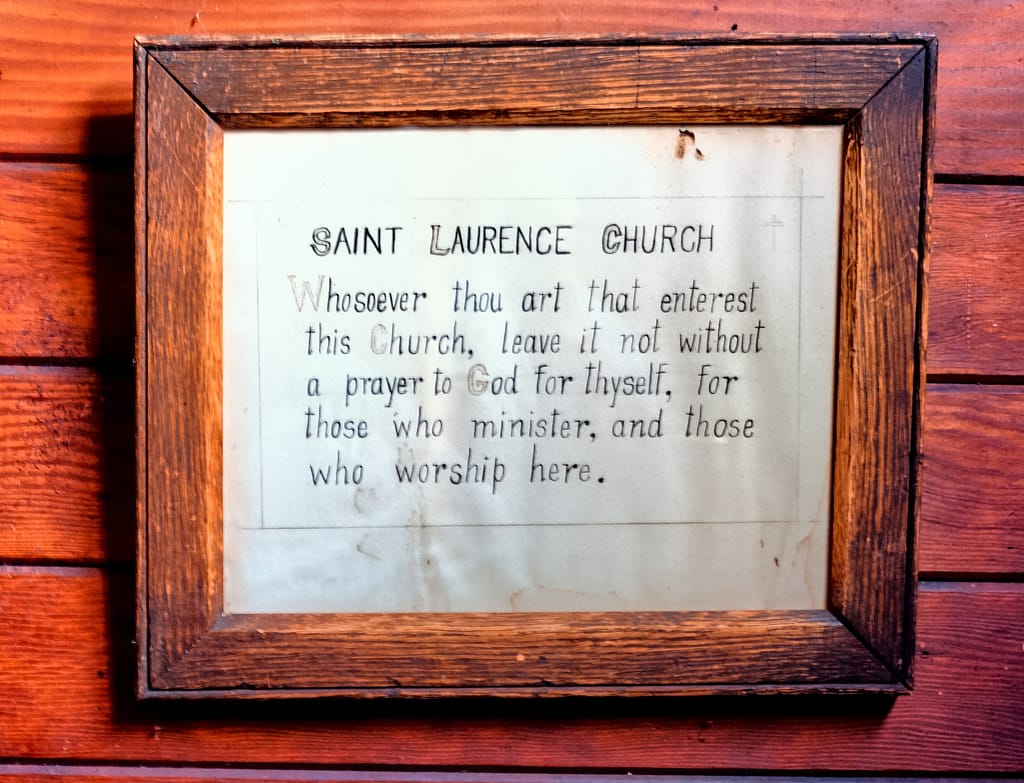 The framed invocation in the church vestibule.